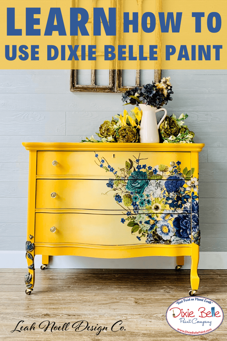 Beautiful dresser chalk painted yellow and a rub-on furniture transfer has been added that has blue flowers. Stage with blue and yellow flowers on top.