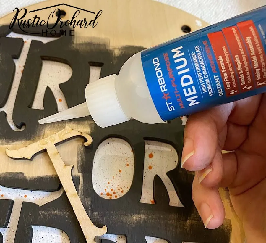 Gluing Wooden Features on Wooden Halloween Sign Painted with Dixie Belle Paint