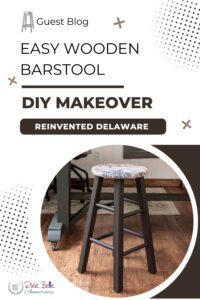 A brown painted wooden barstool with a vintage seat sitting on a brown wooden floor; the words Guest Blog Easy Wooden Barstool DIY Makeover Reinvented Delaware are printed above the photo.