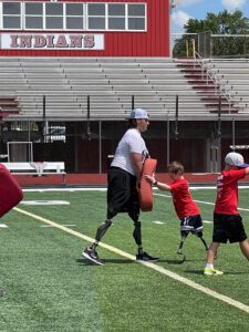 Photo of Calder H playing football with youth