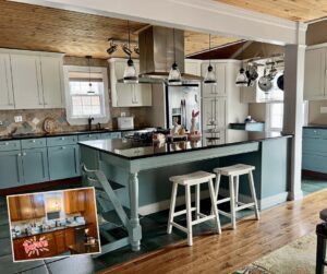 An "after" photo of a painted kitchen, the upper cabinets are painted white and the lower cabinets are painted blue.