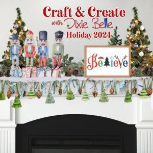 A white painted fireplace mantle with Christmas decor on it; a Christmas tree on each side, four nutcrackers with gifts, a white framed Believe painted sign and the One Tree-Mendous Water Slide Garland Pack strung and hanging across the mantle.