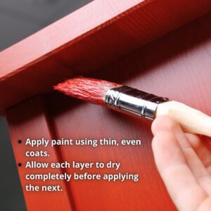 A red painted piece of furniture with a hand holding a paint brush that is applying paint to the furniture; tips for applying paint are printed on photo